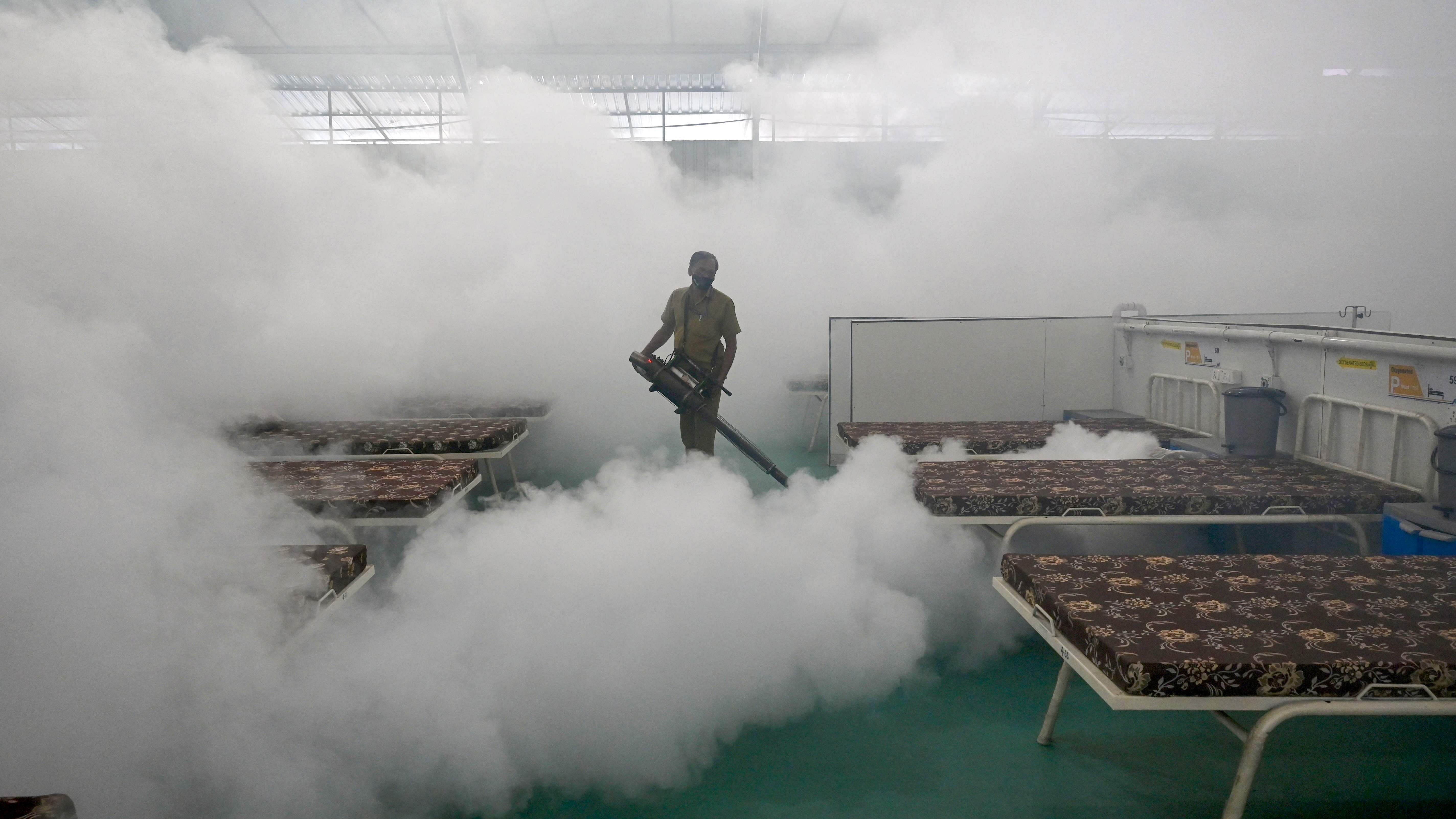 A civic authority worker fumigates inside a soon to be Covid-19 hospital. Representative Image. Credit: AFP File Photo