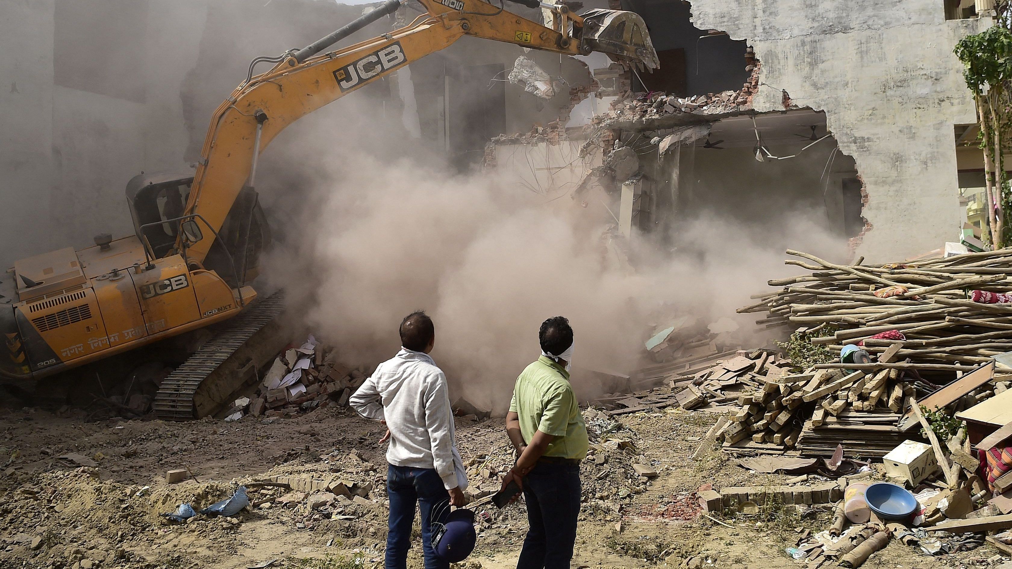 A bulldozer is being used to demolish the illegal structures of the residence of Javed Ahmed, a local leader who was allegedly involved in the recent violent protests against Bharatiya Janata Party (BJP) former spokeswoman Nupur Sharma's incendiary remarks about Prophet Mohammed. Credit: AFP Photo