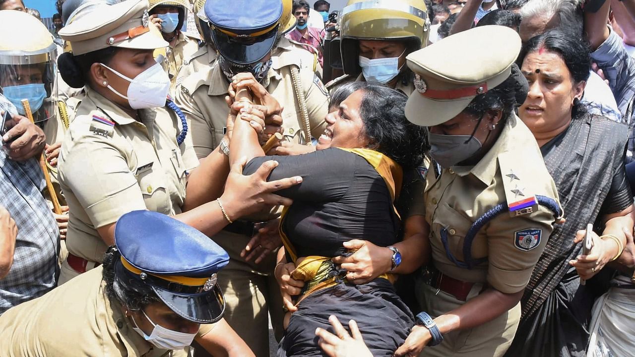 Police personnel detain Mahila Congress activists during their protest demanding resignation of Kerala Chief Minister Pinarayi Vijayan in connection with his alleged involvement in a gold smuggling case, in Thiruvananthapuram. Credit: PTI Photo