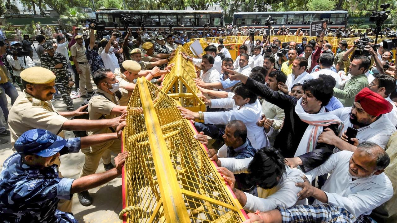 Police stop Congress workers during a protest outside the AICC office against summoning of party leader Rahul Gandhi by the Enforcement Directorate (ED) in connection with the National Herald case, in New Delhi, Wednesday, June 15, 2022. Credit: PTI Photo