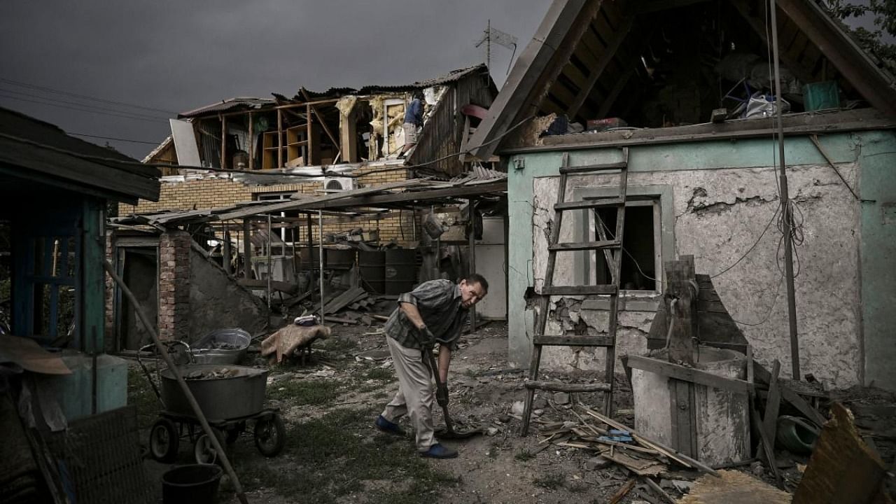 A man cleans his destroyed house from debris after a strike in the city of Dobropillia in the eastern Ukrainian region of Donbas. Credit: Reuters photo
