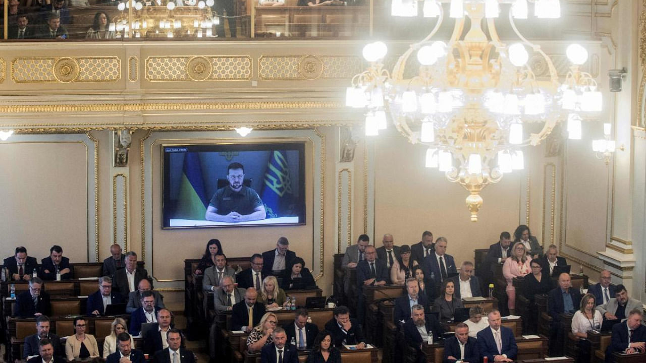 Ukrainian President Volodymyr Zelenskyy is seen on a screen as he addresses members of both houses of the Czech Parliament via video conference in Prague. Credit: AFP Photo