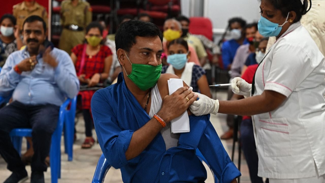 A health worker inoculates a man with a dose of the Covishield vaccine against the Covid-19 coronavirus at a vaccination camp in Chennai. Credit: AFP Photo