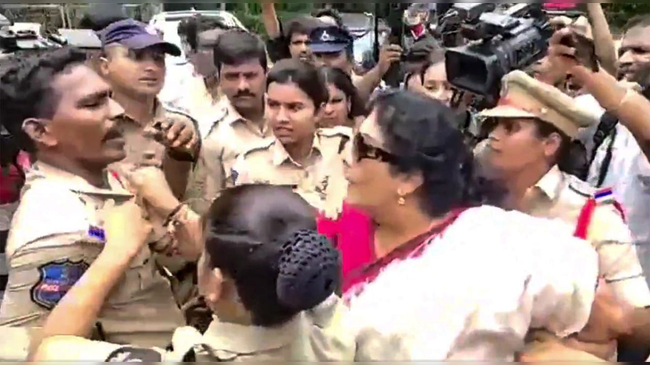Senior Congress leader Renuka Chowdary holds a cop's collar during a protest over Congress leader Rahul Gandhi's questioning by the Enforcement Directorate in connection with the National Herald case, in Hyderabad. Credit: PTI Photo/Twitter/@krishanKTRS