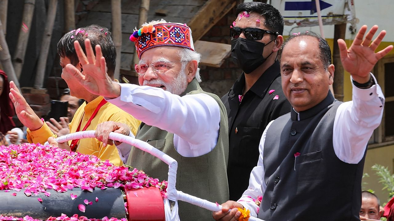 Prime Minister Narendra Modi and Himachal Pradesh Chief Minister Jai Ram Thakur during a road show, in Dharamshala. Credit: PTI Photo