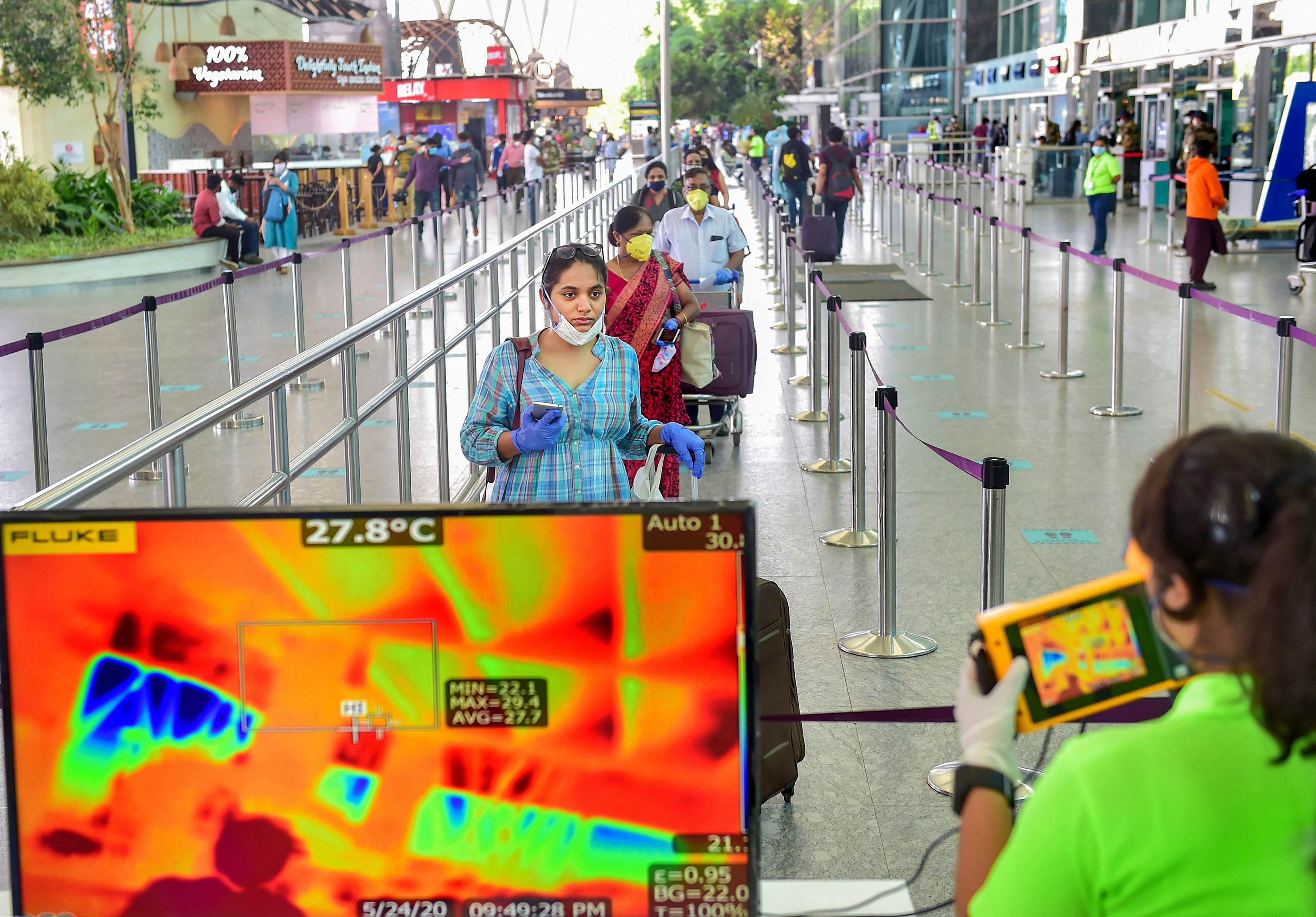 Passengers undergo thermal scanning on their arrival at Kempegowda International Airport. Credit: PTI Photo