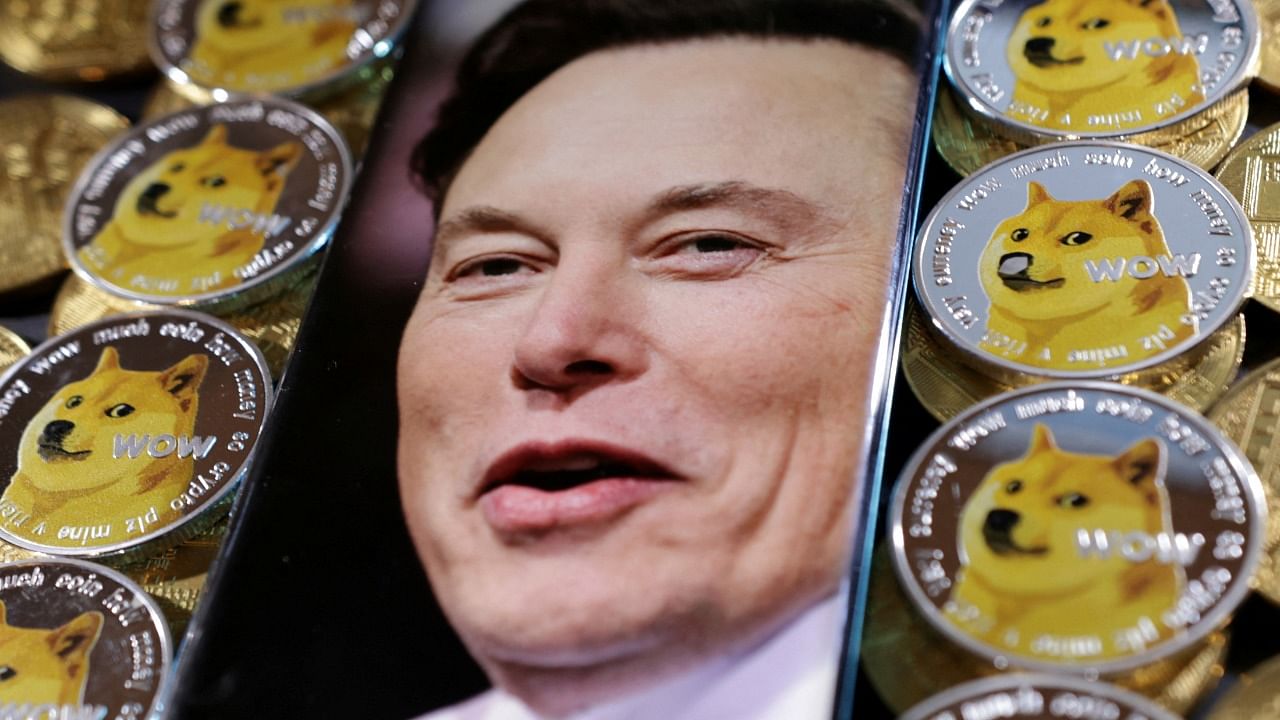 A photo of Elon Musk is displayed on a smartphone placed on representations of cryptocurrency Dogecoin. Credit: Reuters Photo