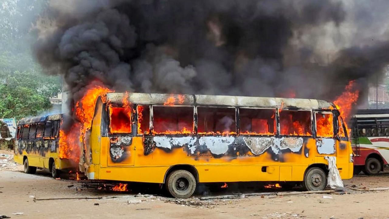 Smoke billows from buses after they were set on fire by people protesting against Centre's 'Agnipath' scheme, in Aurangabad, Friday, June 17, 2022. Credit: PTI Photo