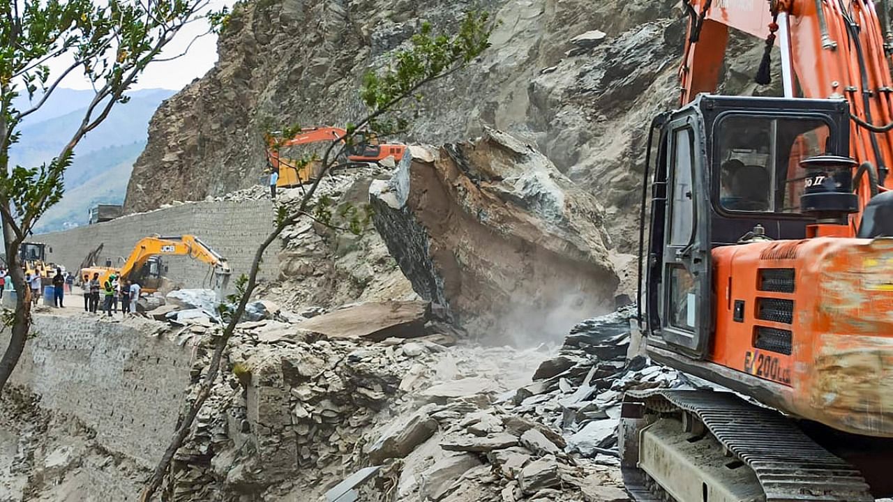 Restoration work underway after a boulder-slide blocked the Jammu-Srinagar national highway at Romepadi near Banihal, J & K, Friday, June 17, 2022. Credit: PTI Photo