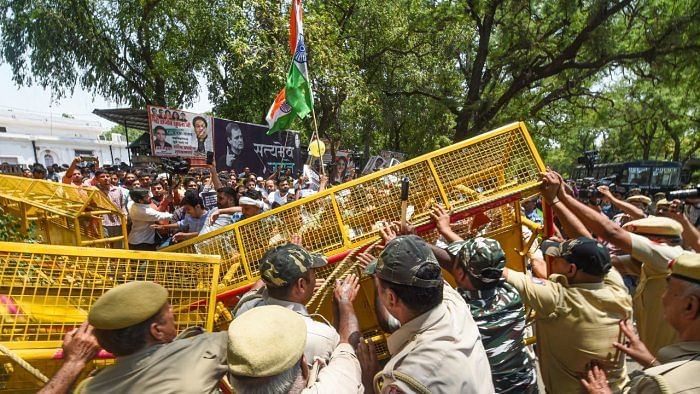 olice stop Congress workers who were staging a protest outside the AICC office against summoning of party leader Rahul Gandhi by the Enforcement Directorate (ED) in connection with the National Herald case. Credit: PTI Photo