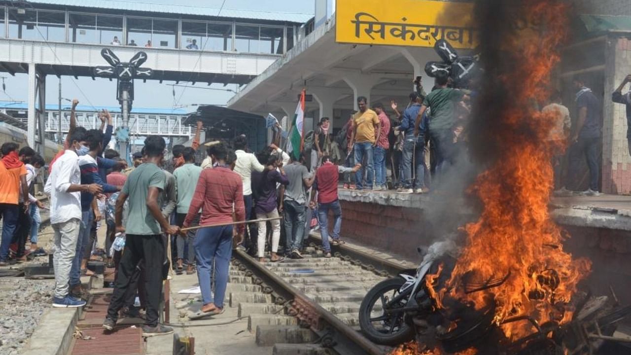 Protesters set ablaze a two-wheeler during a protest against Agnipath Recruitment Scheme, at Secunderabad railway station in Secunderabad on Friday, June 17, 2022. Credit: IANS Photo