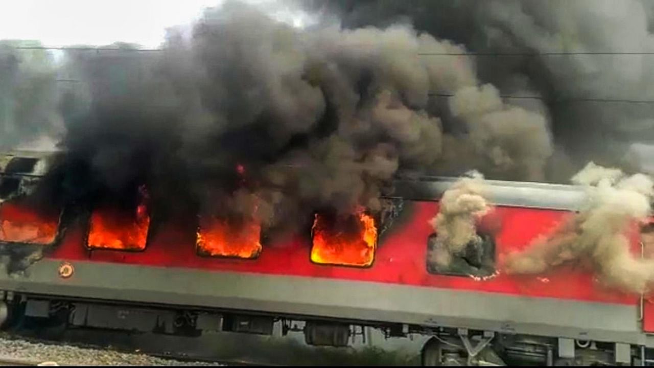 Jammu Tawi Guwahati Express train set on fire by a mob in protest against the Centre's 'Agnipath' scheme, in Hajipur, Friday, June 17, 2022. Credit: PTI Photo