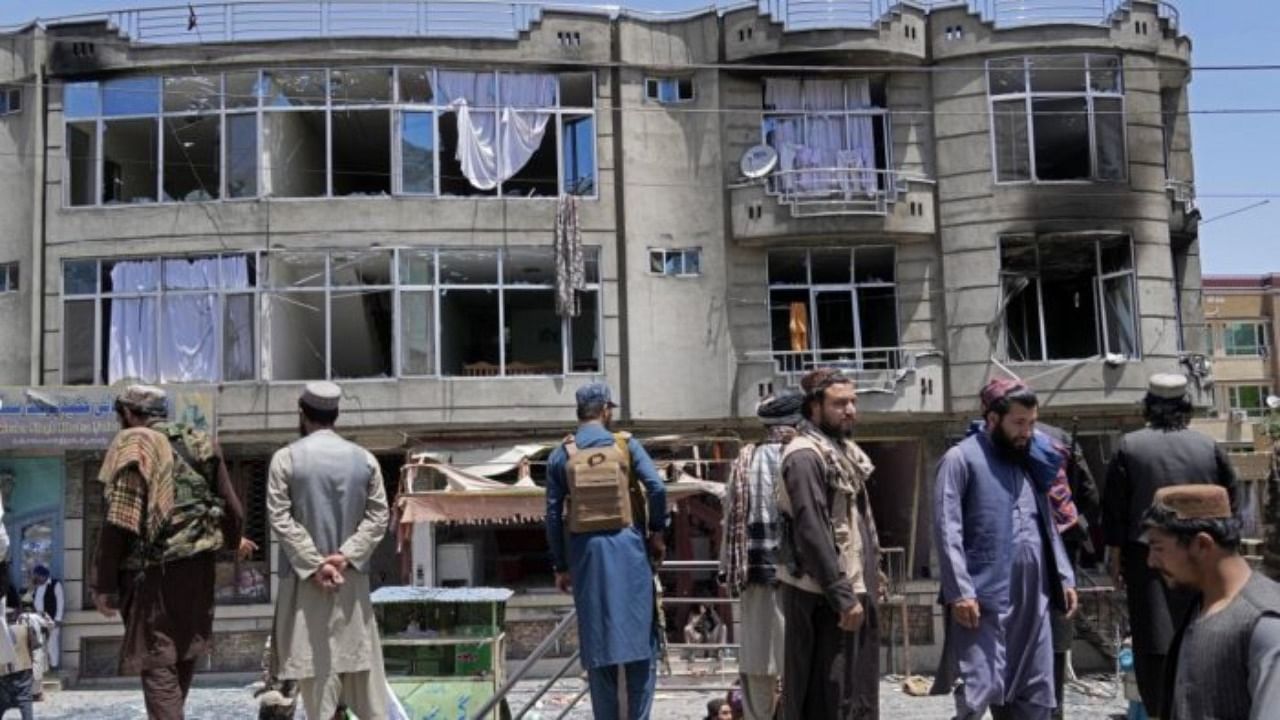 Taliban fighters stand guard at the site of an explosion in front of a Sikh temple in Kabul. Credit: AP/PTI photo