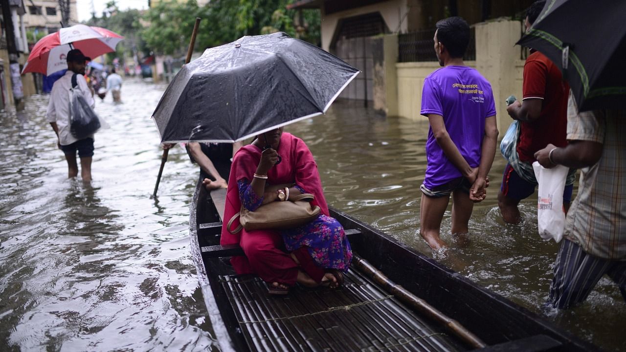 A woman sits in a country boat as it moves through flood waters in Sylhet, Bangladesh, Monday, June 20. Credit: AP Photo