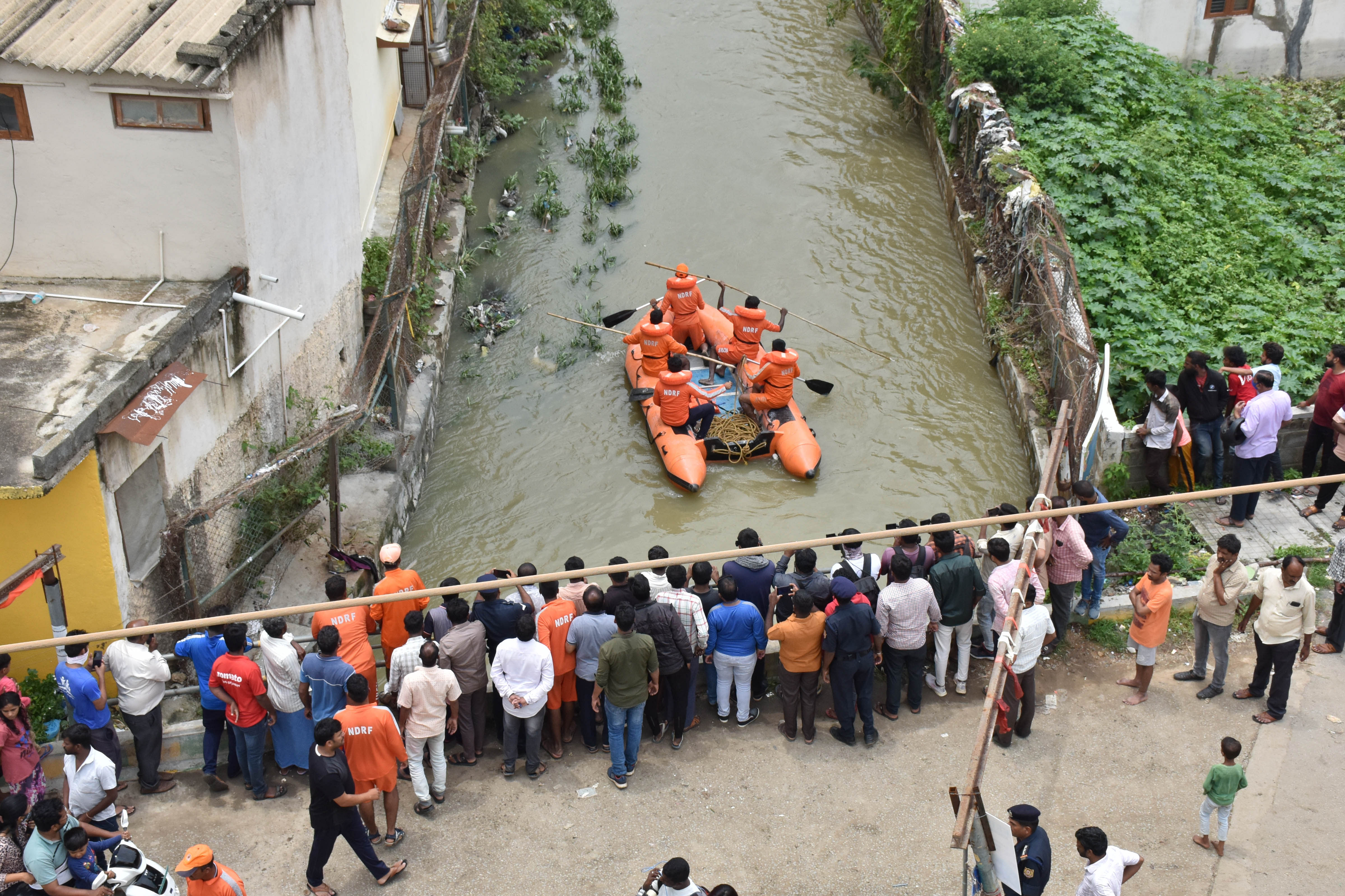 National Disaster Rescue Force (NDRF) search for the missing man who fell into a stormwater drain at the Gayathri layout in Whitefield late last night after heavy rain fall in Bengaluru on Saturday. Credit: DH Photo by BK Janardhan