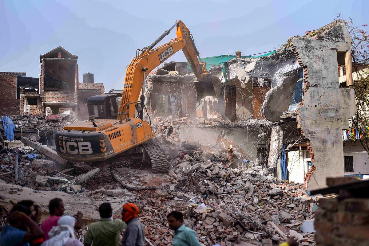 Bulldozer being used to demolish the 'illegally constructed' residence of Javed Ahmed, a local leader who was allegedly the key conspirator of violent protests against now-suspended BJP leaders' remarks on Prophet Muhammad, in Prayagraj. Credit: PTI File Photo