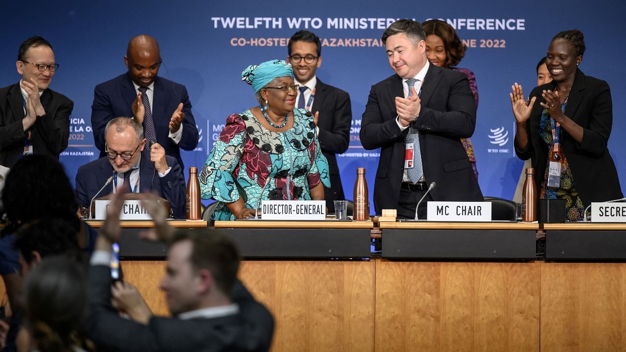Conference chair Timur Suleimenov claps next to World Trade Organization Director-General Ngozi Okonjo-Iweala after a closing session of a World Trade Organization Ministerial Conference at the WTO headquarters in Geneva. Credit: Reuters Photo