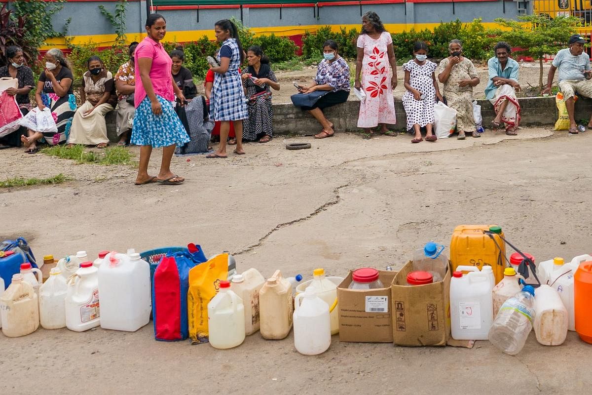 People queue up to buy kerosene for domestic use at a supply station in Colombo on June 17, 2022. Credit: AFP Photo
