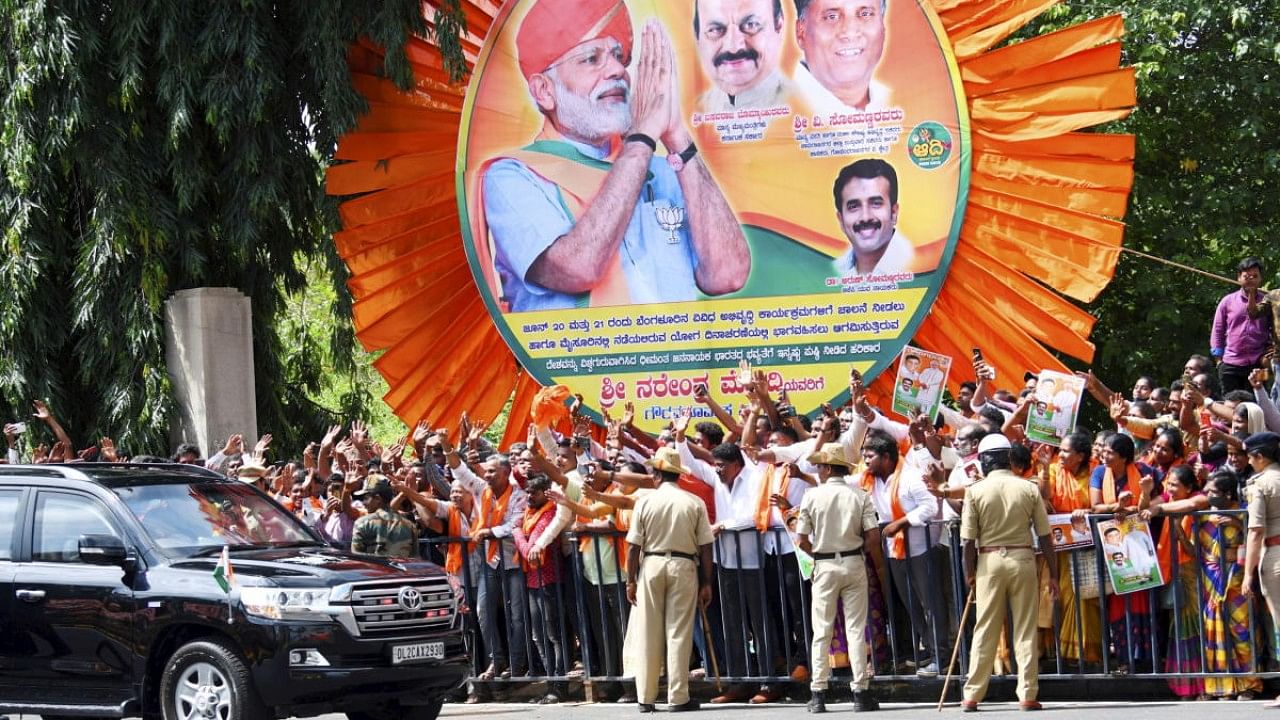 Prime Minister Narendra Modi's convoy being welcomed by locals during his visit to Bengaluru. Credit: PTI Photo