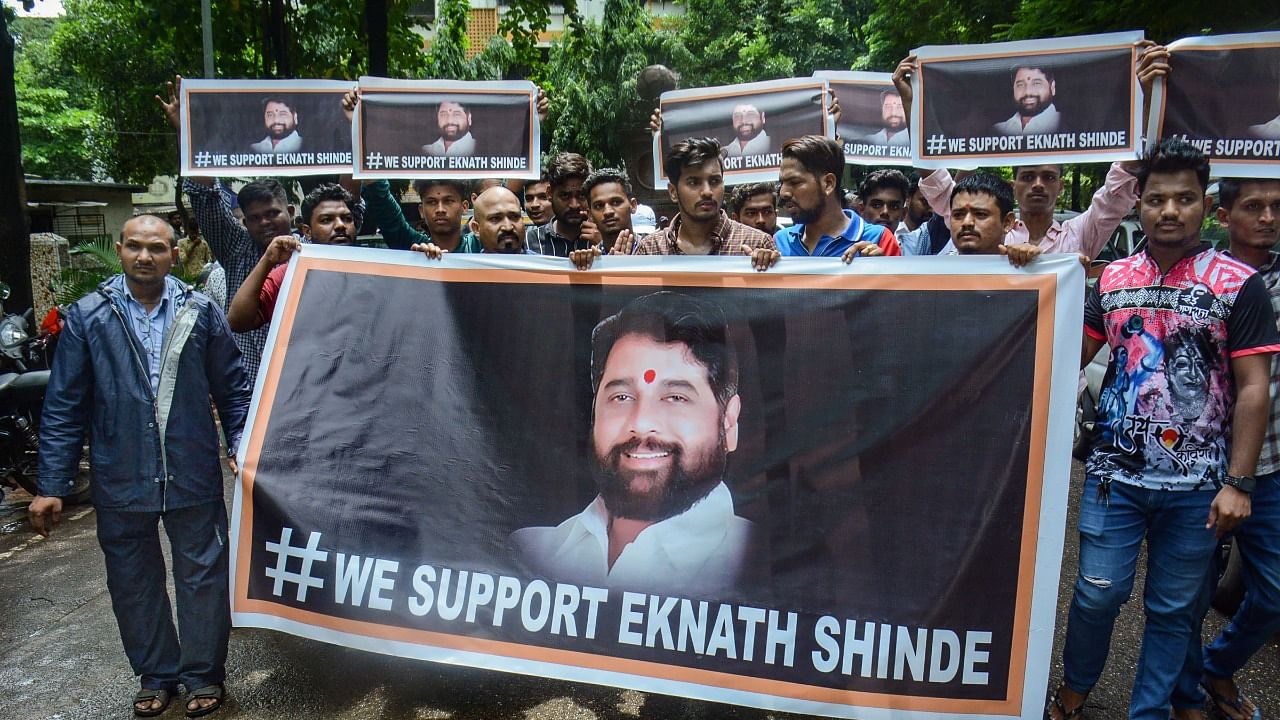 Supporters of rebel Shiv Sena leader Eknath Shinde outside his residence, in Thane. Credit: PTI Photo