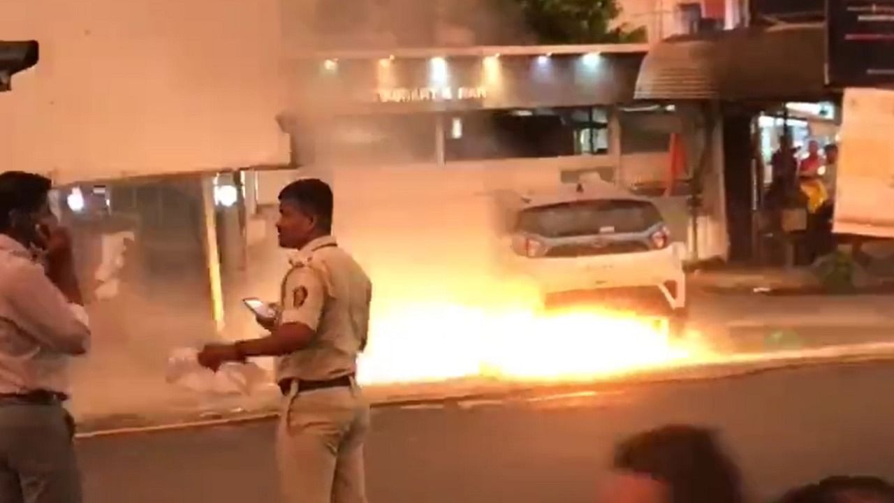 The video, which has gone viral, showed firefighters trying to put out the fire in Tata Motor's Nexon EV car in Mumbai. Credit: Twitter Screengrab/@KamalJoshi108