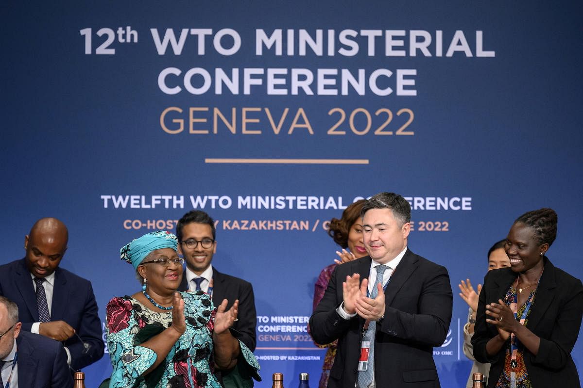 WTO Director-General Ngozi Okonjo-Iweala claps next to conference chair Timur Suleimenov after a closing session of a World Trade Organization Ministerial Conference at the WTO headquarters in Geneva. Credit: Reuters photo
