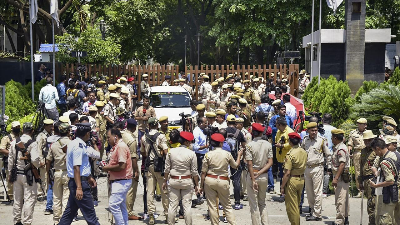 Police personnel guard outside a hotel as a rebel Shiv Sena MLA arrives to join other dissident MLAs, in Guwahati, Thursday, June 23, 2022. Credit: PTI Photo