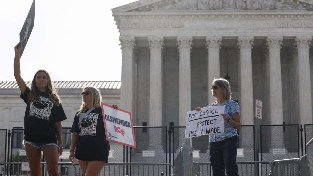 An abortion rights activist protests next to anti-abortion rights activists in front of the US Supreme Court Building. Credit: AFP Photo