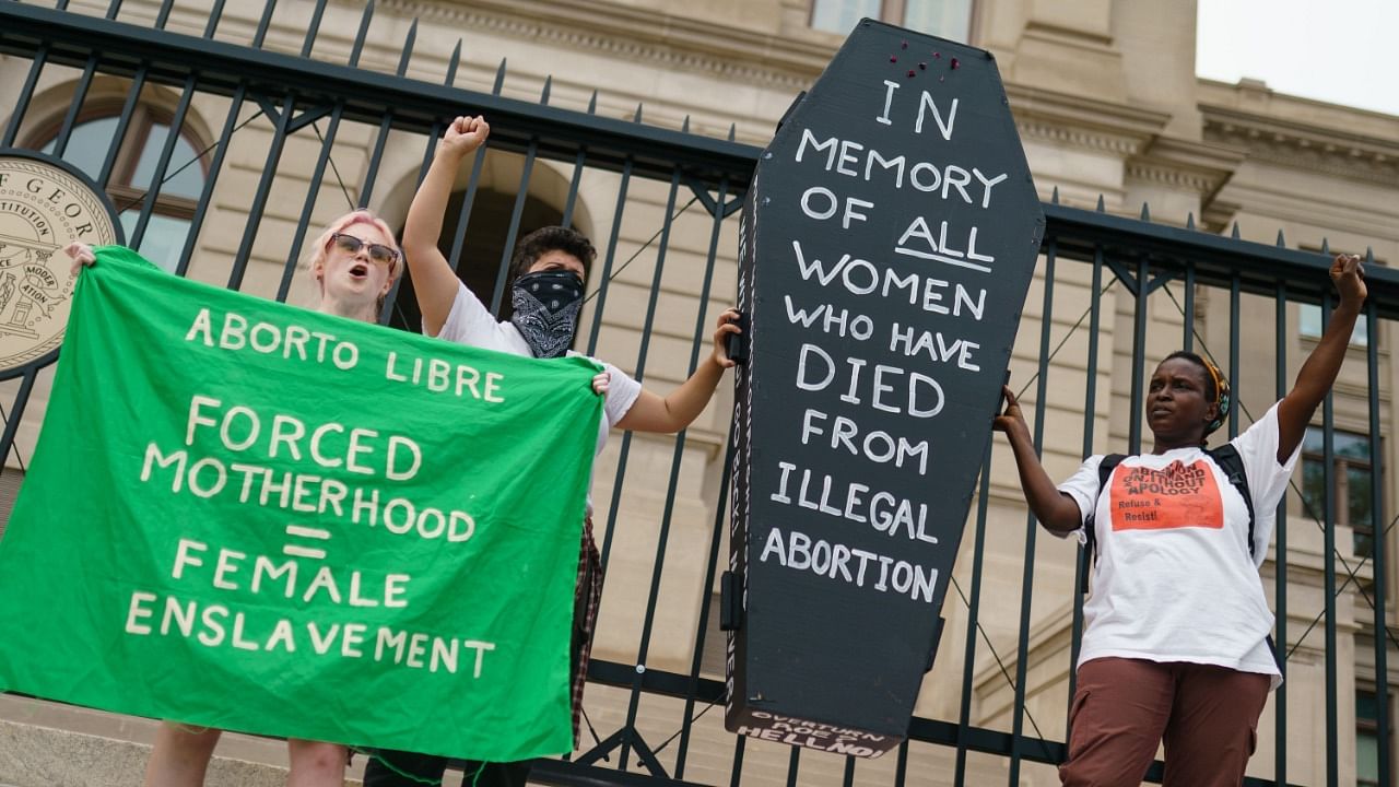  Protesters hold up a coffin in memory of women who have died from illegal abortions to protest the Supreme Court's decision in the Dobbs v Jackson Women's Health case on June 24, 2022. Credit: AFP Photo