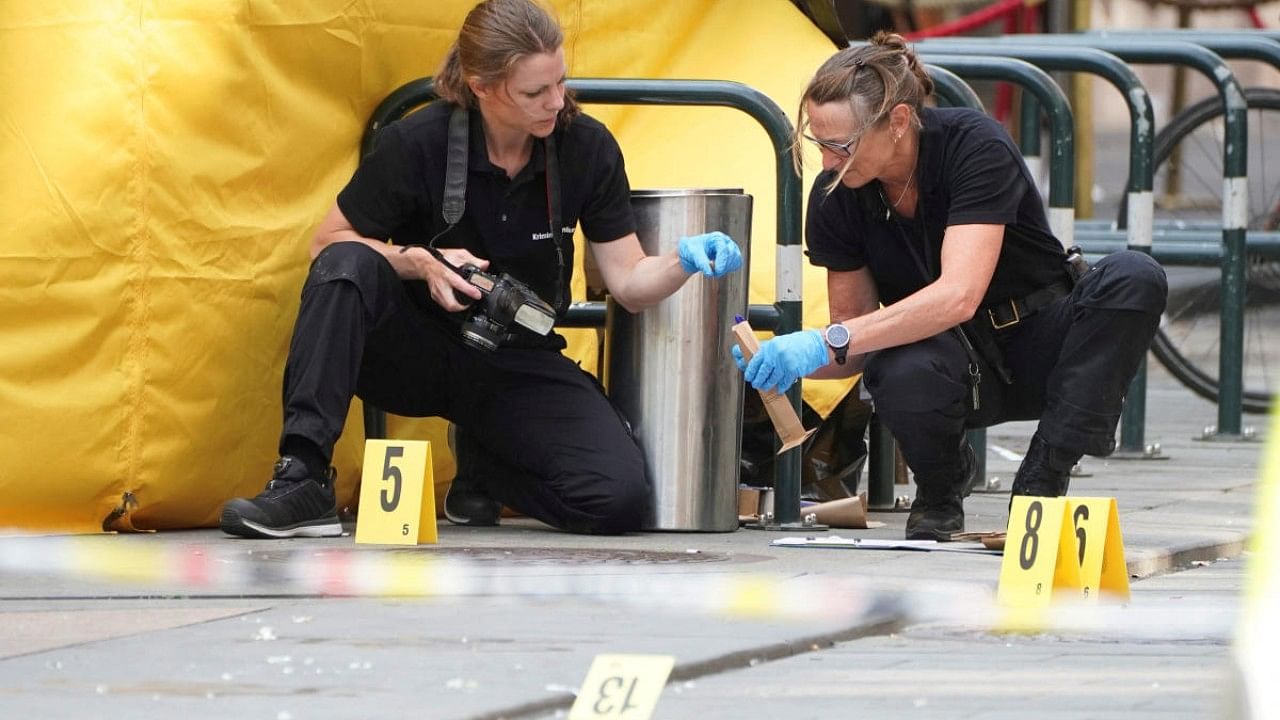 Forensic technicians work at the scene following a shooting at the London Pub, a popular gay bar and nightclub, in central Oslo. Credit: Reuters Photo