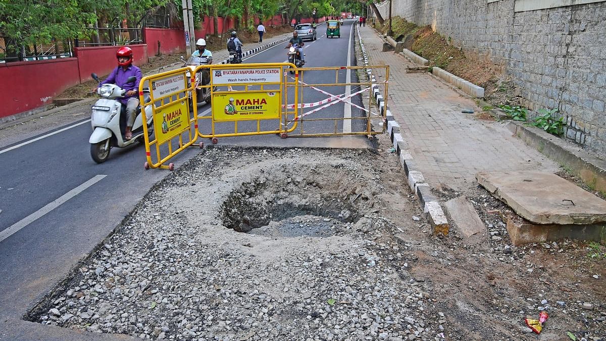 The sinkhole on the road newly asphalted for Prime Minister Narendra Modi's visit. Credit: DH Photo/Ranju P