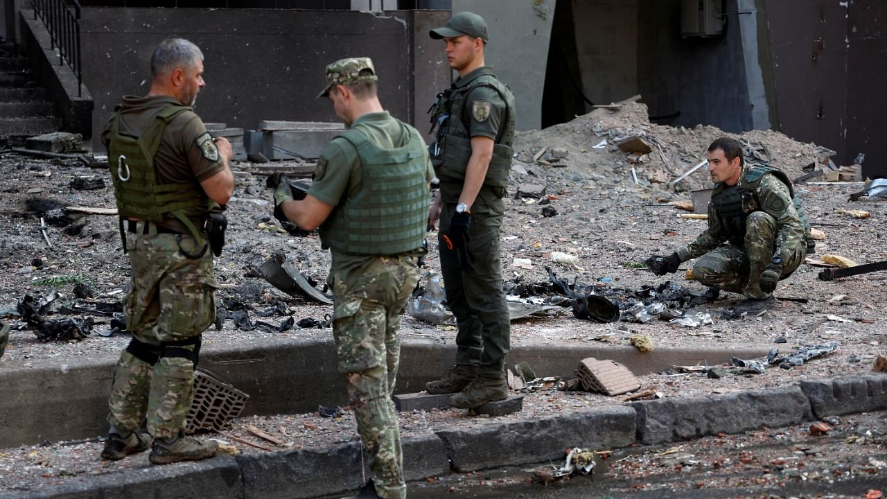 Officers inspect the remains of missile outside a residential building hit by a Russian missile strike, as Russia's attack on Ukraine. Credit: Reuters Photo
