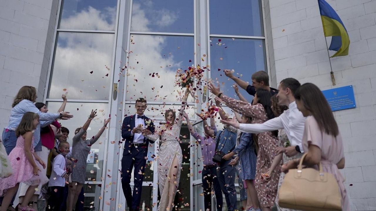 A growing number of couples in Ukraine are speedily turning love into matrimony because of the war with Russia. Credit: AP Photo
