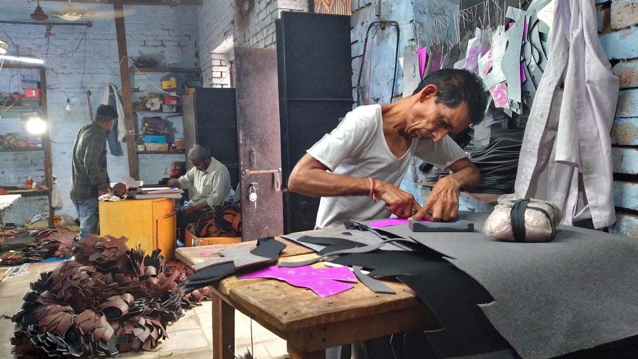 In 2021, 5,577 MSMEs closed operations in India. In this picture, a worker makes shoes in a micro-scale unit in Uttar Pradesh. Credit: Reuters photo