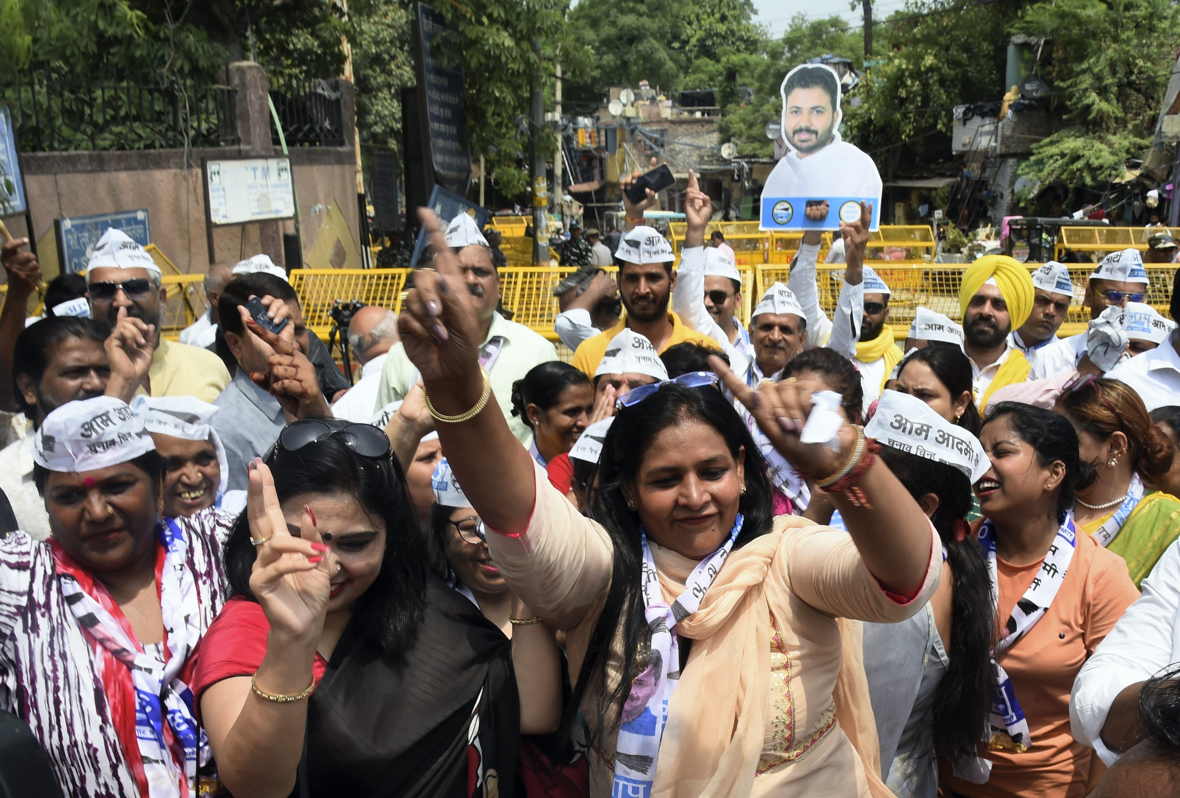 AAP workers celebrate after the party candidate Durgesh Pathak's lead during the counting of votes of Rajinder Nagar by-elections. Credit: PTI Photo