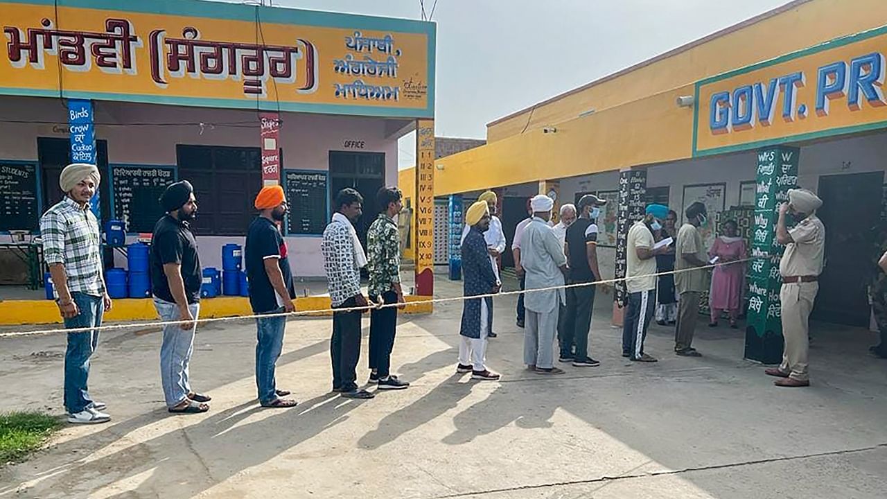 People queue up at a polling station to cast their votes for the Sangrur Lok Sabha bypolls, in Sangrur, Thursday, June 23, 2022. Credit: PTI Photo