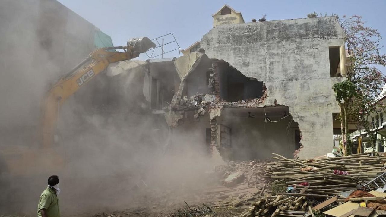 A bulldozer being used to demolish the illegal structures of the residence of Javed Ahmed, a local leader who was allegedly involved in the recent violent protests against Bharatiya Janata Party (BJP) former spokeswoman Nupur Sharma's remarks about Prophet Mohammed, in Prayagraj on June 12, 2022. Credit: AFP Photo