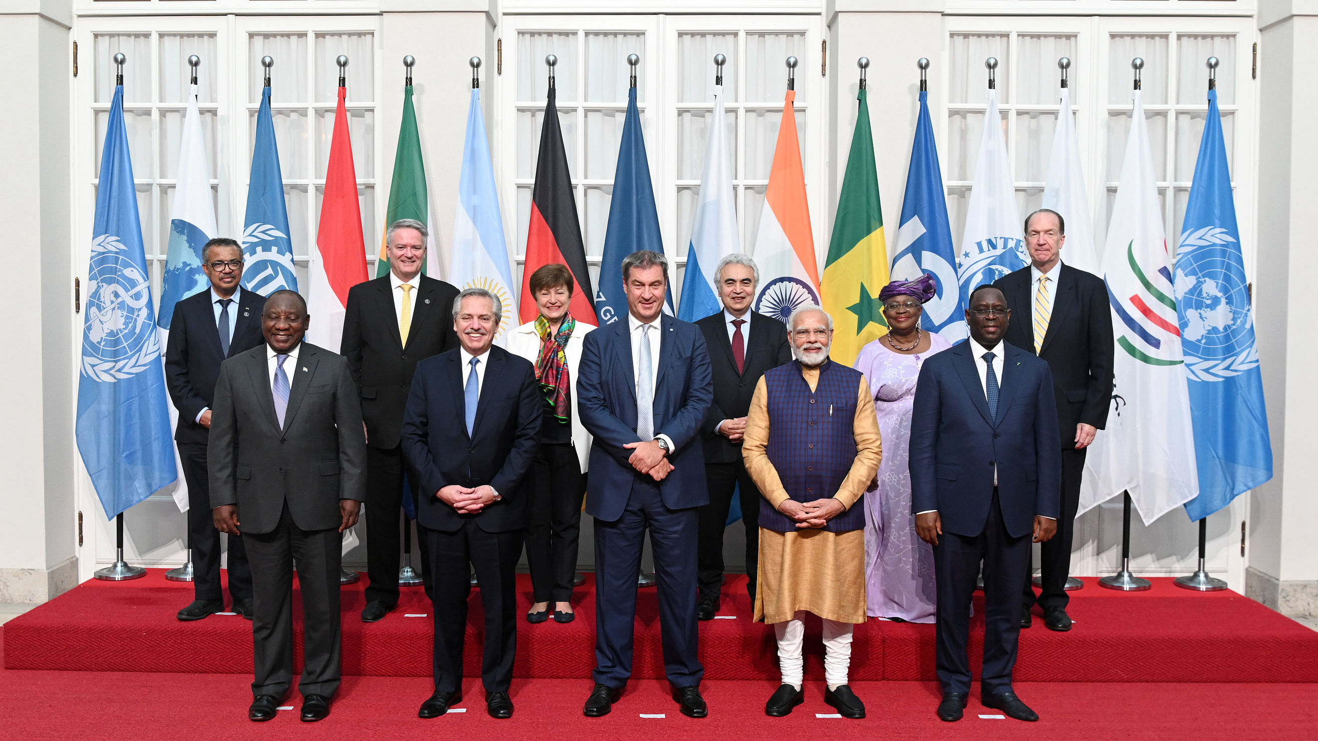 (Front Line - L-R) South African President Cyril Ramaphosa, Argentine President Alberto Angel Fernandez, Bavarian Minister-President Markus Soeder, Indian Prime Minister Narendra Modi and Senglese President Macky Sall, (Back - L-R) WHO Secretary-General Tedros Adhanom Ghebreyesus, OECD Secretary-General Mathias Cormann, IMF Director Kristalina Georgiewa, IEA Executive Director Fatih Birol, WTO Secretary General Ngozi Okonjo-Iweala and President of the World Bank David Malpass pose for a group photo at a reception in the Residence on the sidelines of the 48th G7 summit. Credit: PTI Photo
