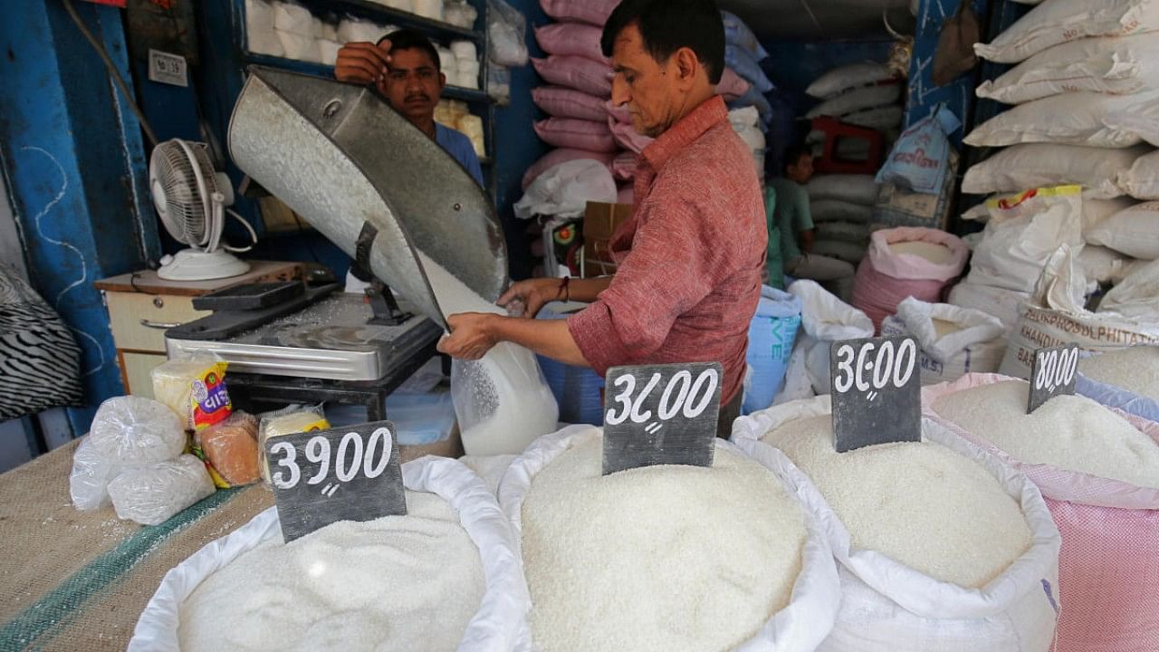 A man packs sugar for sale inside a shop at a marketplace in Ahmedabad. Credit: Reuters File Photo