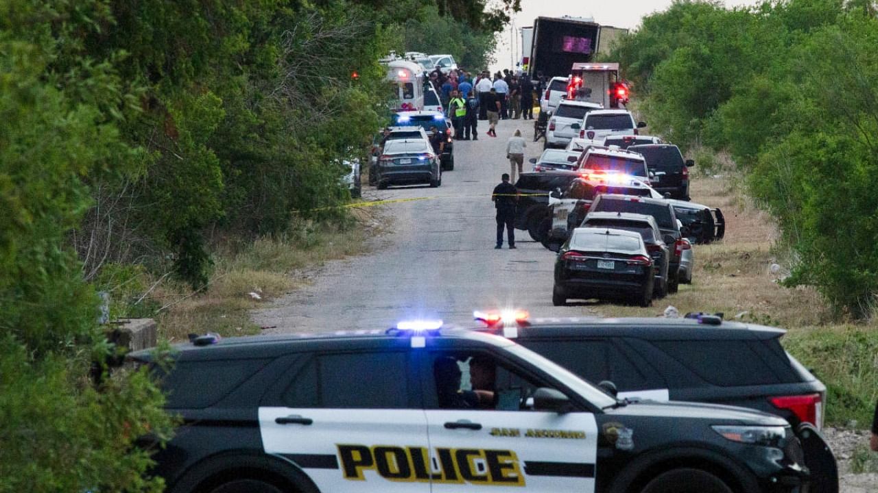 Law enforcement officers work at the scene where people were found dead inside a trailer truck in San Antonio, Texas, U.S. June 27, 2022. Credit: Reuters Photo