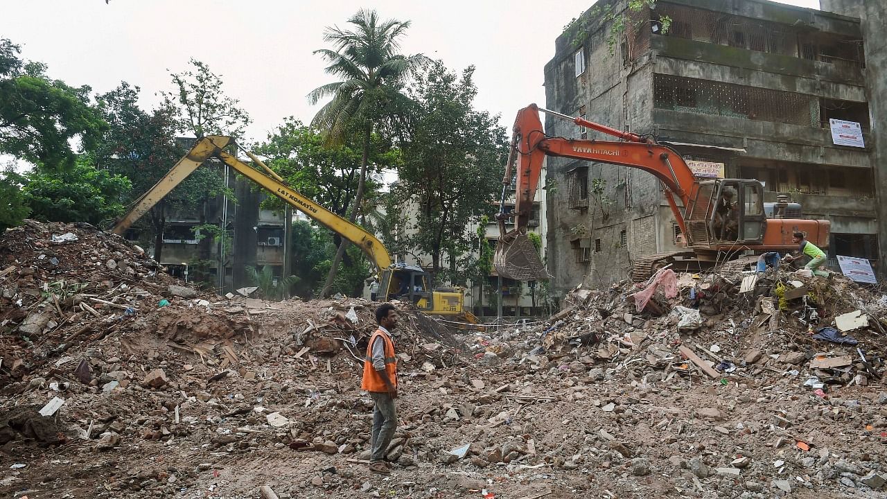 Workers clear debris of the four-storey building which collapsed at Naik Nagar, in Kurla East, in Mumbai. Credit: PTI Photo
