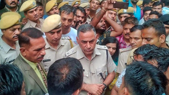 Police personnel interact with locals after the murder of Kanhaiya Lal, in Udaipur, Tuesday, June 28, 2022. Lal, a tailor was attacked by an assailant with a sharp weapon while the other filmed the crime, according to officials. Credit: PTI Photo
