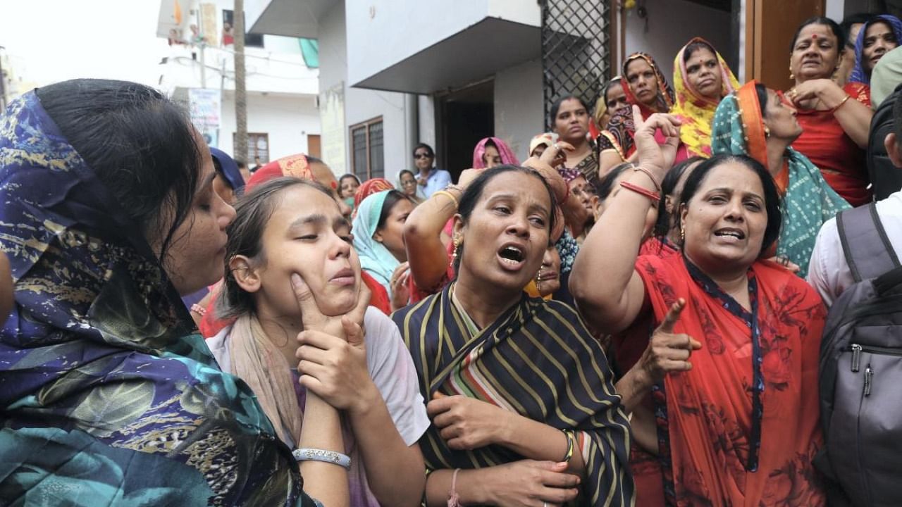 Family members mourn during the funeral procession of tailor Kanhaiya Lal in Udaipur. Credit: PTI file photo
