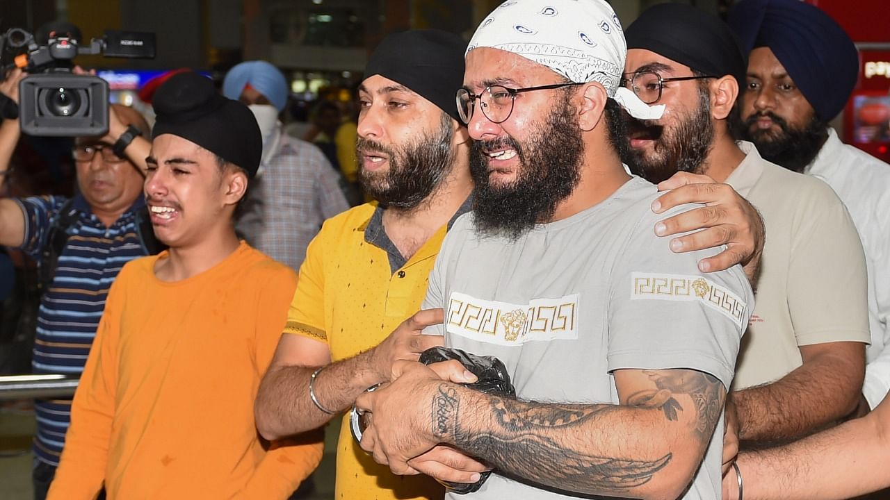 Sons and other family members of Sawinder Singh, who was killed in an attack on a gurdwara in Kabul, mourn after receiving his ashes at the IGI Airport, in New Delhi. Credit: PTI Photo