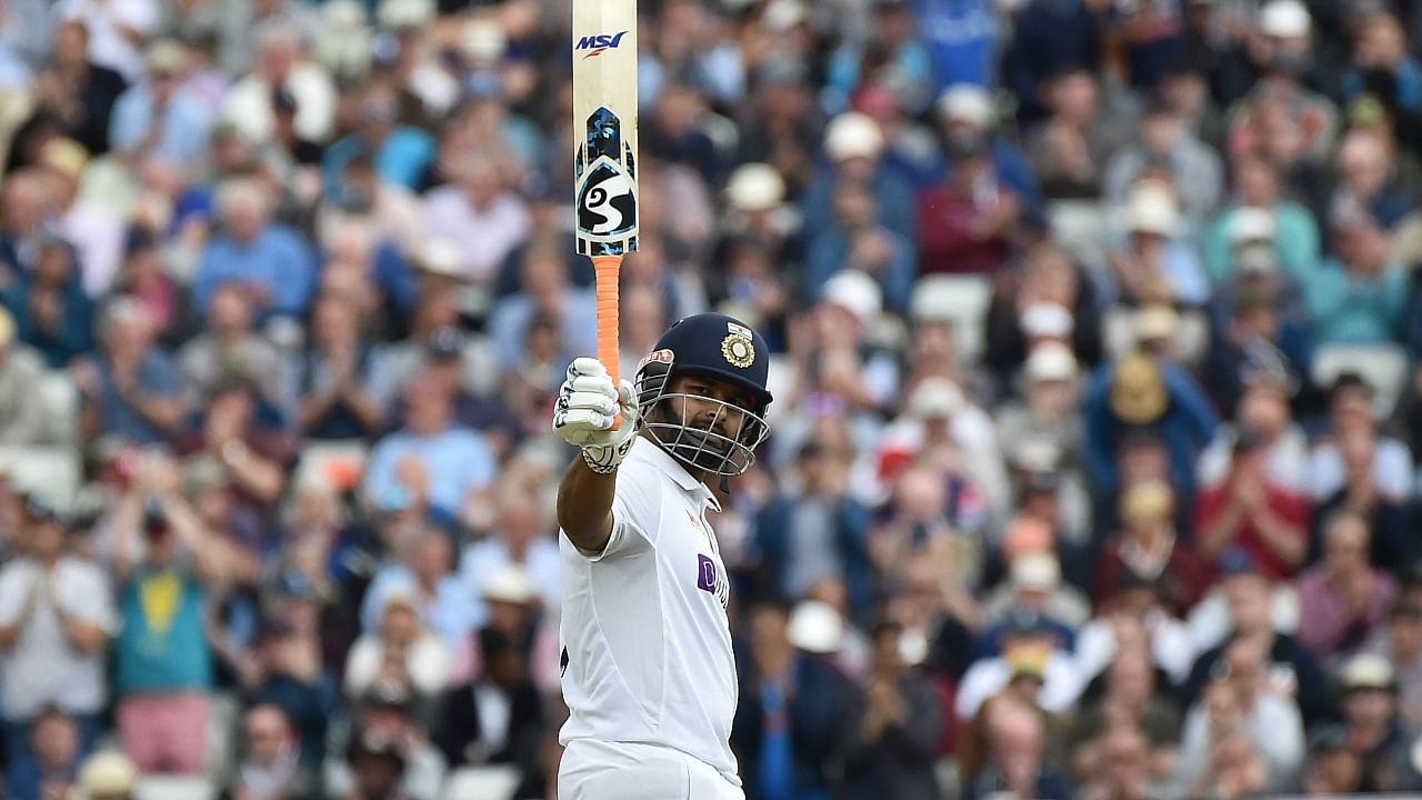 Rishabh Pant raises his bat to celebrate scoring fifty runs during the first day of the fifth cricket test match between England and India at Edgbaston in Birmingham. Credit: AP Photo