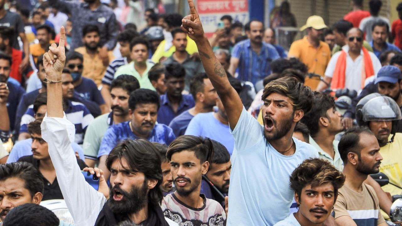 People raise slogans during the funeral procession of tailor Kanhaiya Lal in Udaipur, Wednesday, June 29, 2022. Kanhiaya was murdered Tuesday at his shop by two men for allegedly posting a social media statement in favour of suspended BJP spokesperson Nupur Sharma. Credit: PTI Photo