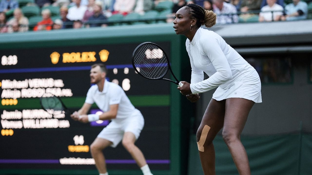 US player Venus Williams (R) and Britain's Jamie Murray (L) in action. Credit: AFP Photo