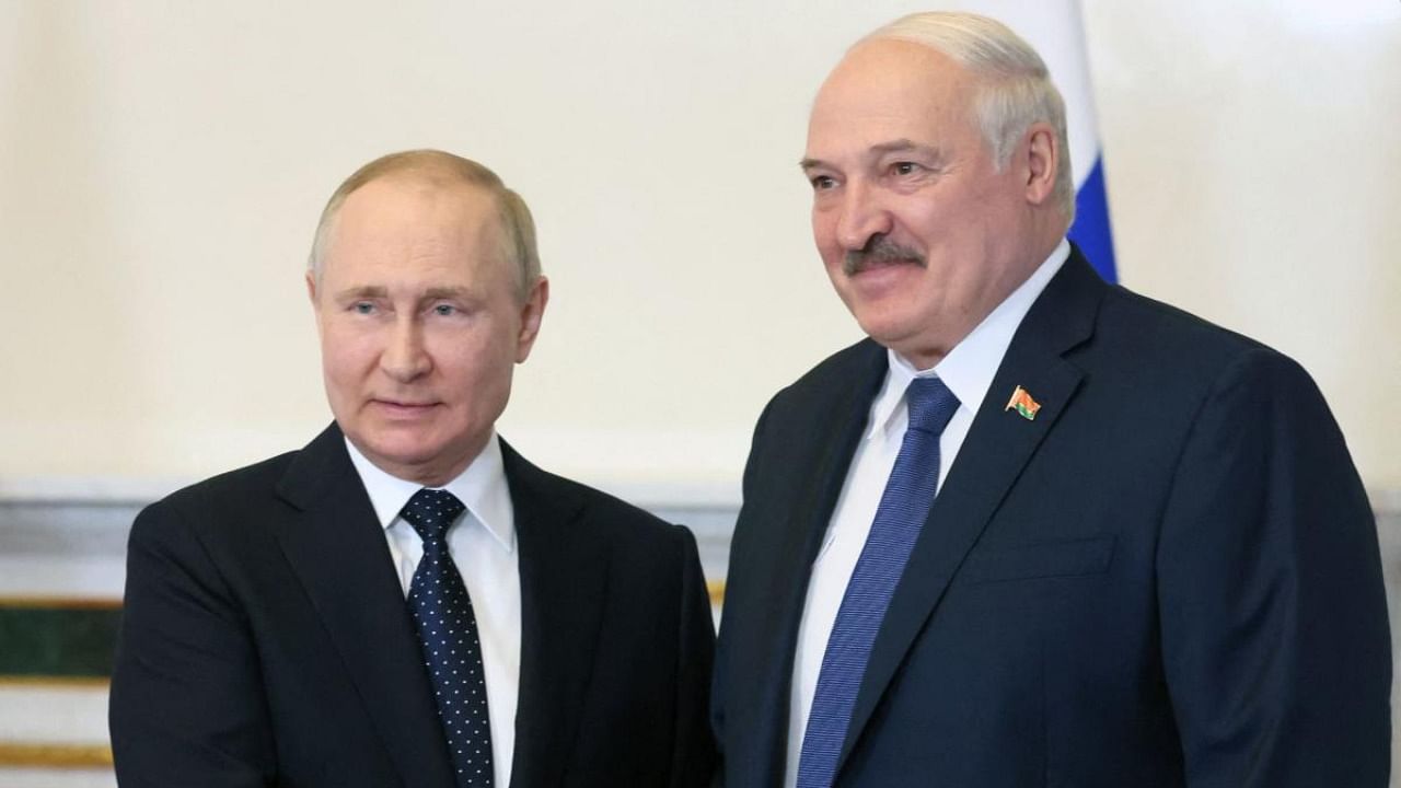 Russian President Vladimir Putin (L) shakes hands with his Belarusian counterpart Alexander Lukashenko during their meeting in Saint Petersburg. Credit: AFP file photo