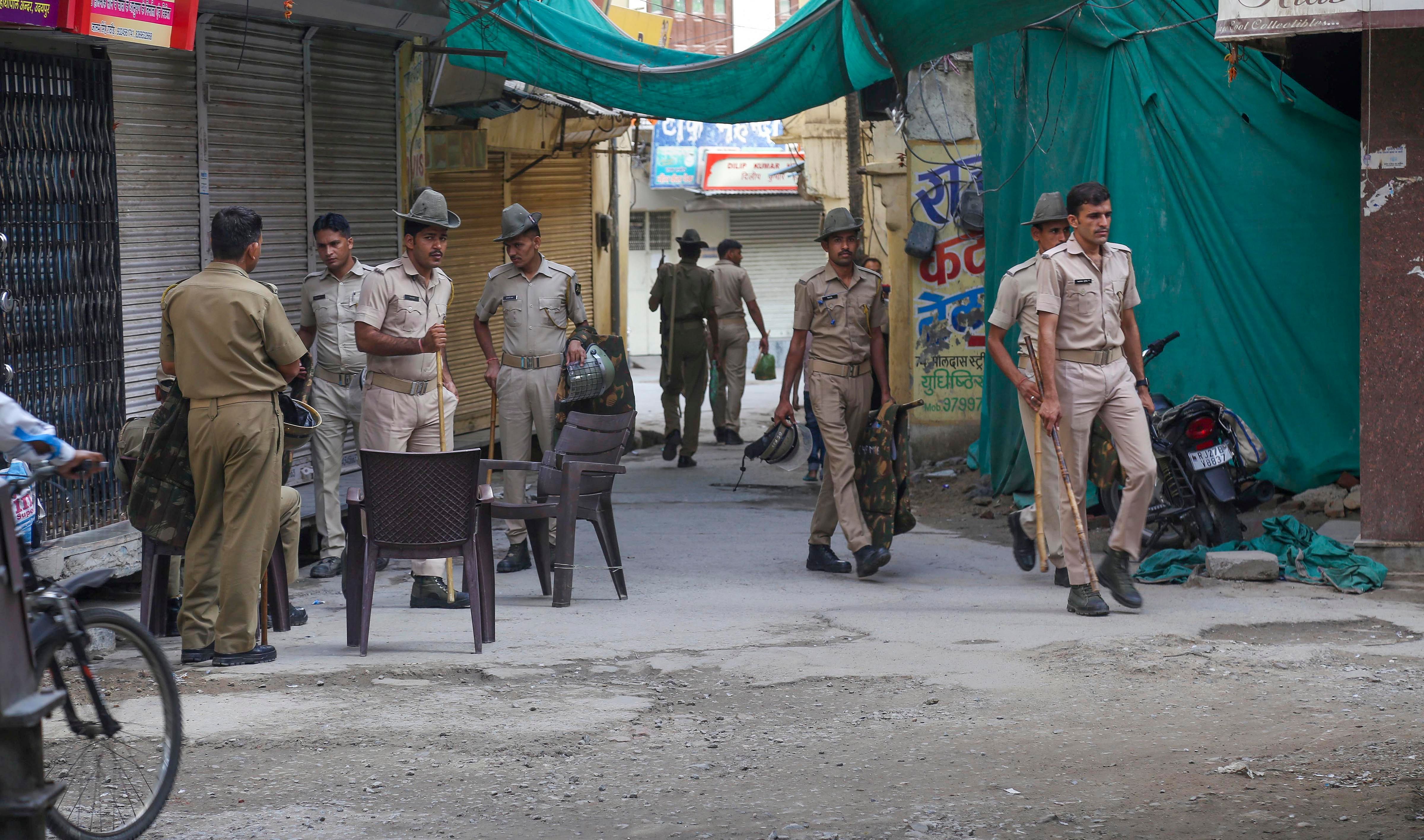 Security personnel deployed outside the closed shop of tailor Kanhaiya Lal during a ten-hour relaxation in the curfew. Credit: PTI Photo
