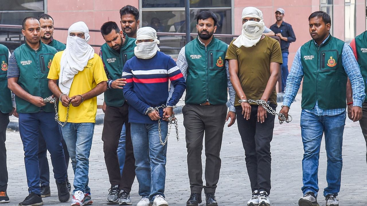 Security personnel with three persons including two main shooters arrested by Delhi Police Special Cell in the Sidhu Moose Wala murder case. Credit: PTI Photo